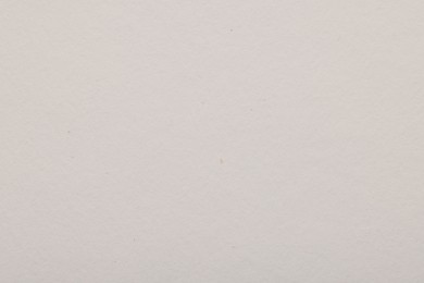 Photo of Texture of light grey paper sheet as background, top view