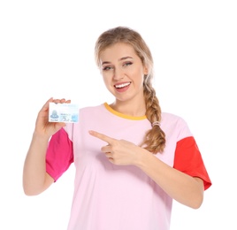 Happy young woman with driving license on white background