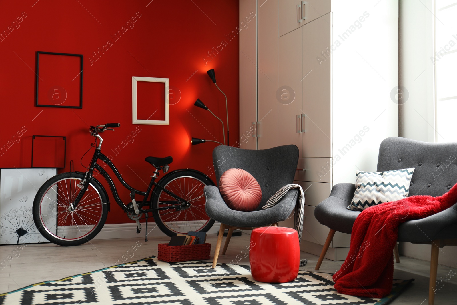 Photo of Modern living room interior with comfortable armchair, sofa and bicycle