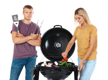 Happy couple cooking on barbecue grill, white background