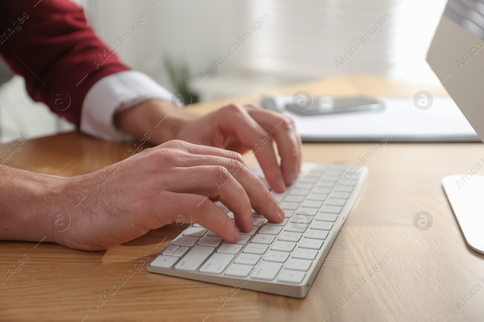 Photo of Freelancer working on computer at table indoors, closeup