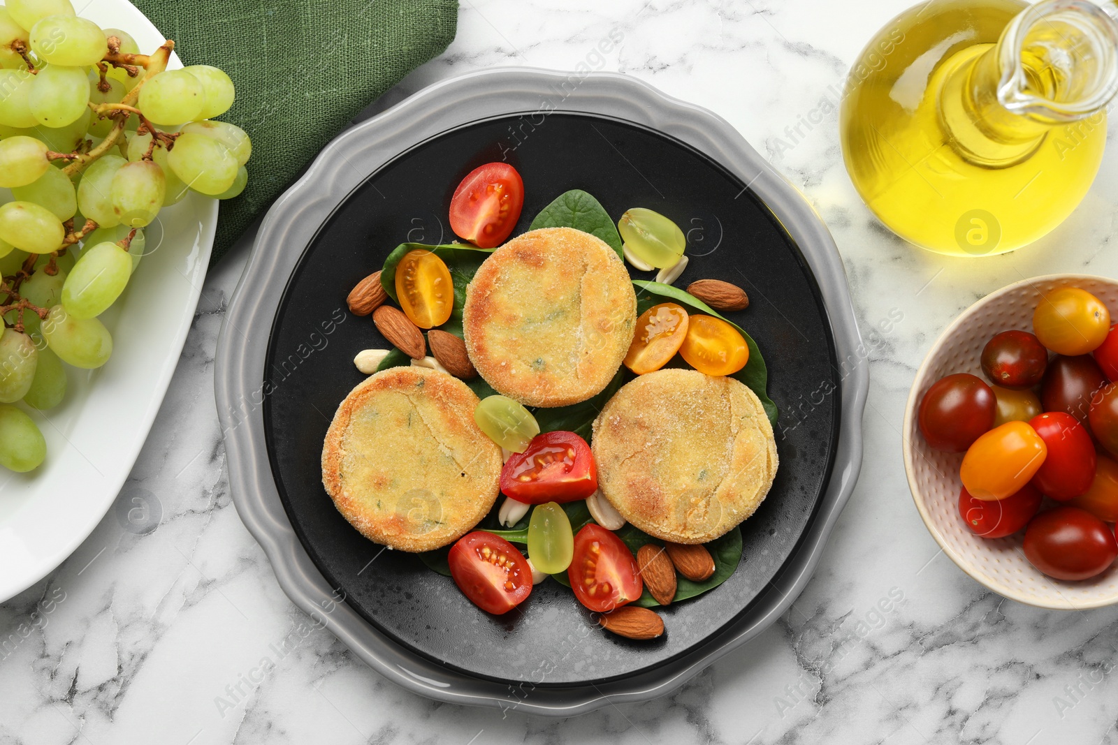 Photo of Plate with healthy dish high in vegetable fats on white marble table, flat lay