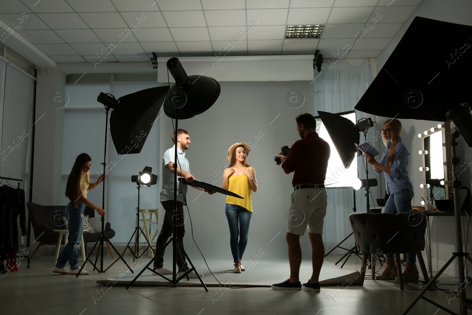 Photo of Professional team working with model in photo studio