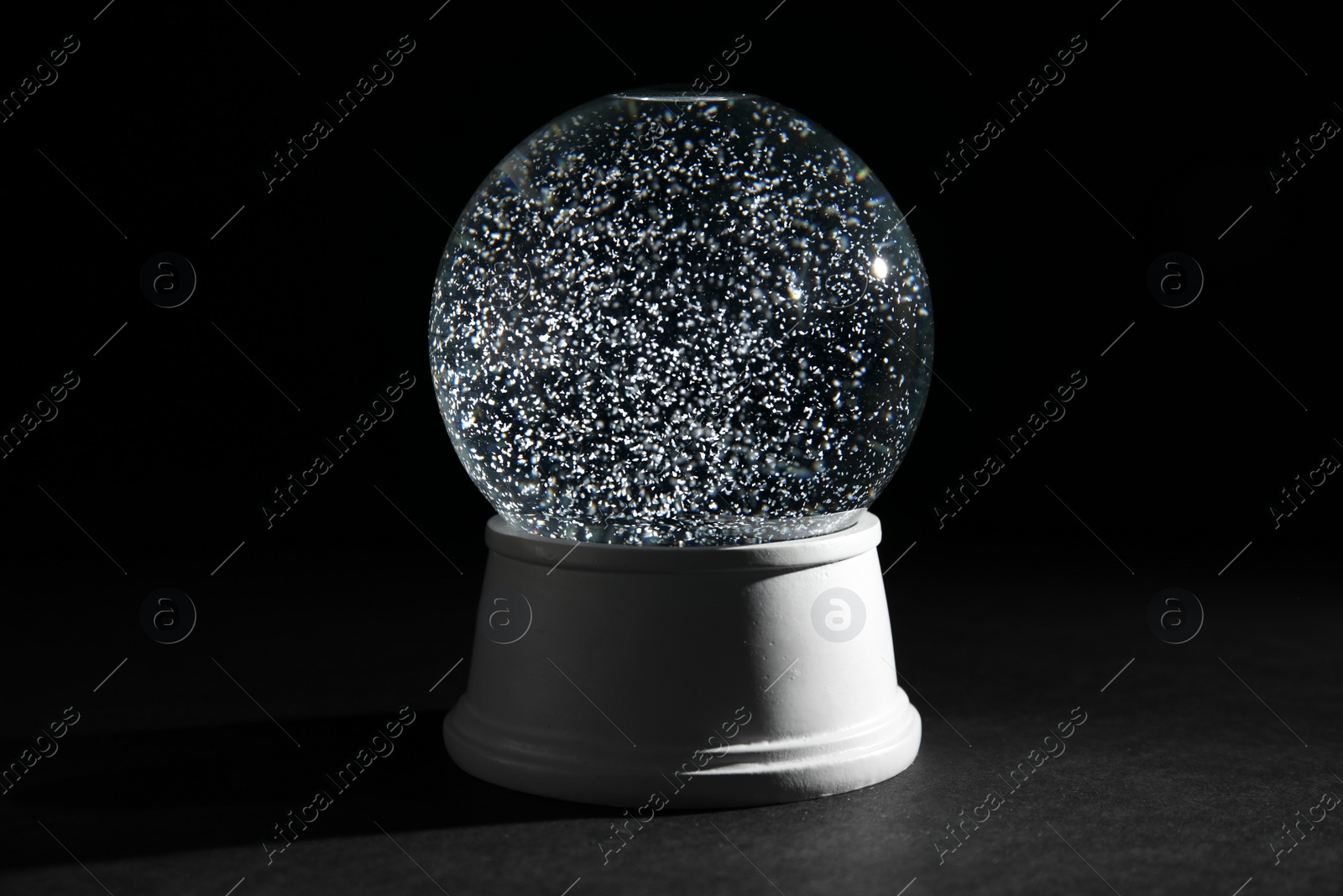 Photo of Magical empty snow globe on dark background