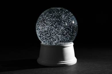 Photo of Magical empty snow globe on dark background