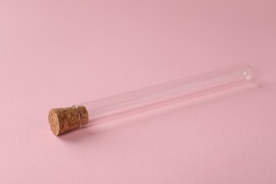 Photo of Test tube on pink background. Laboratory glassware