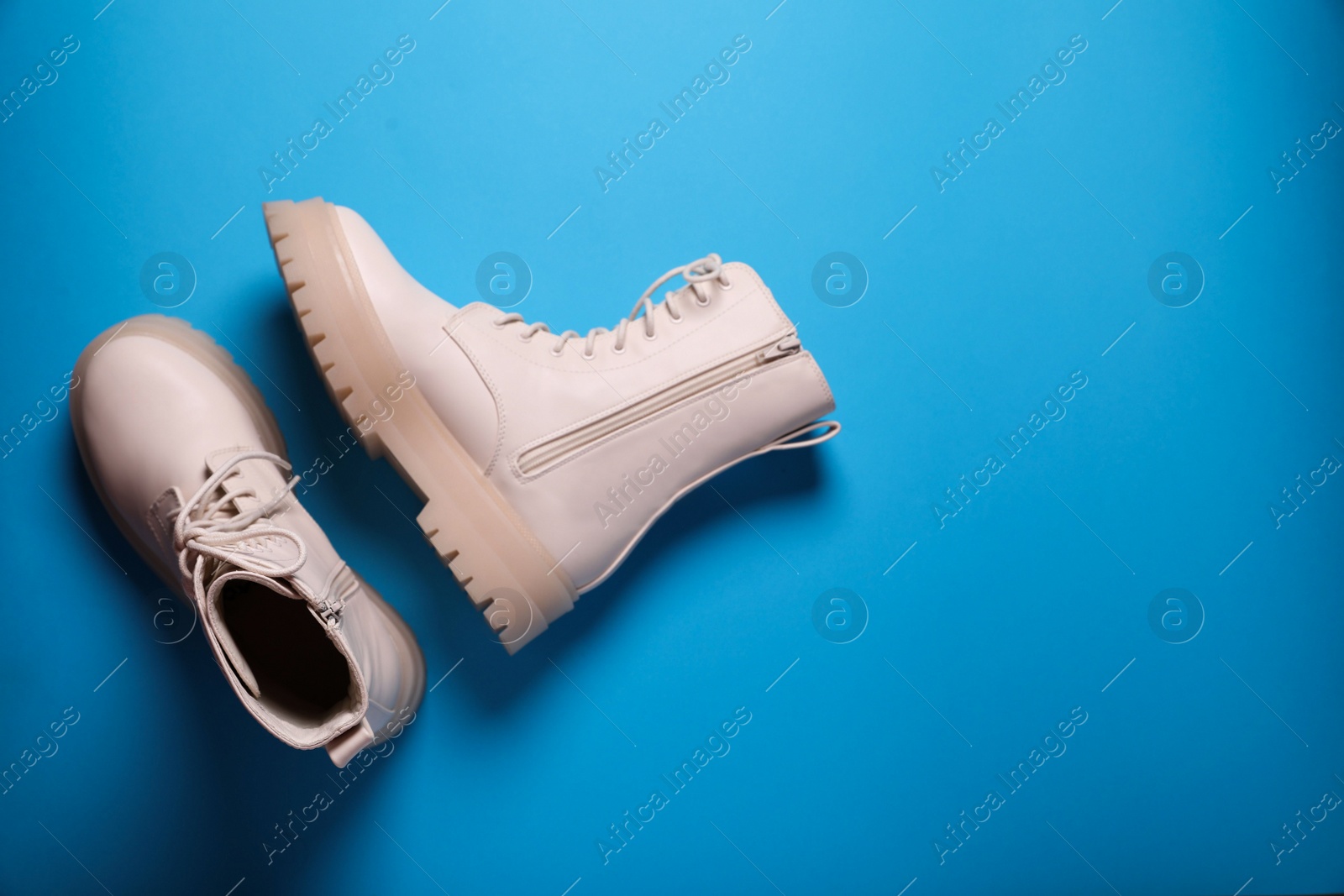 Photo of Pair of stylish leather shoes on light blue background, flat lay. Space for text