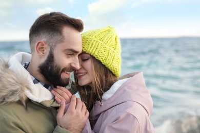 Photo of Lovely young couple spending time near sea