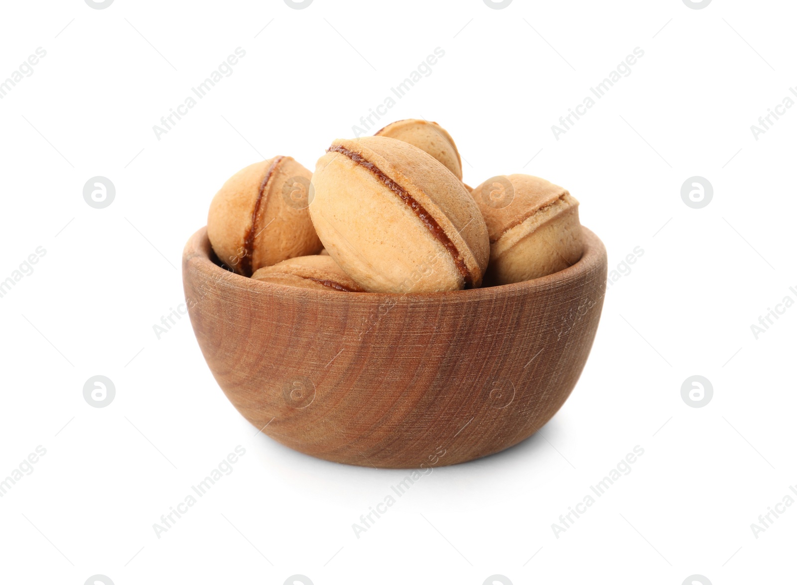 Photo of Delicious nut shaped cookies with boiled condensed milk in wooden bowl on white background