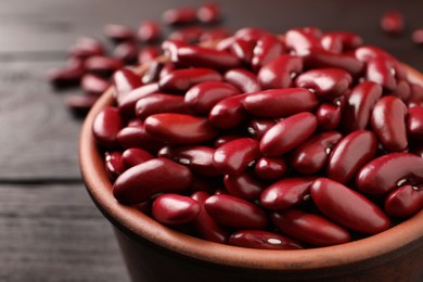 Raw red kidney beans in bowl on table, closeup