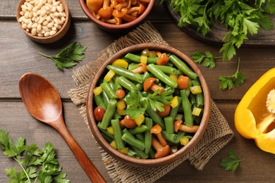 Photo of Tasty salad with green beans served on wooden table, flat lay
