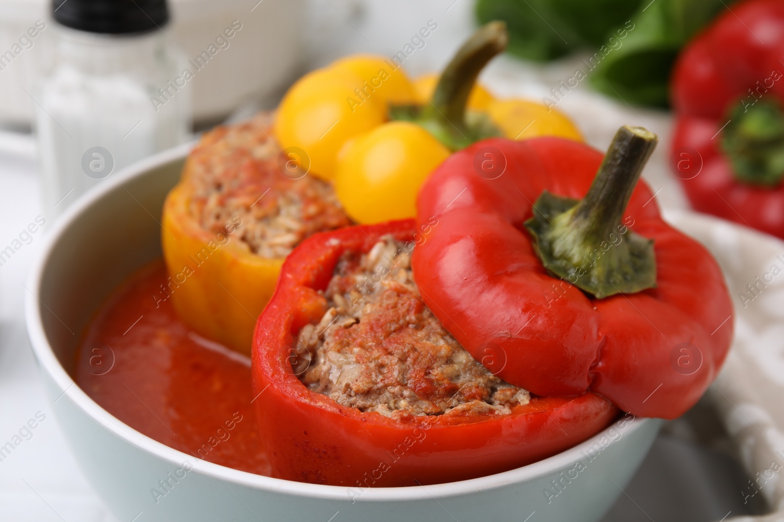 Photo of Delicious stuffed bell peppers on white table, closeup