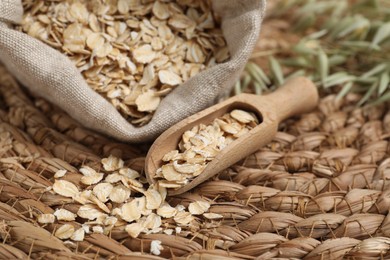 Photo of Scoop and bag with oatmeal on wicker mat