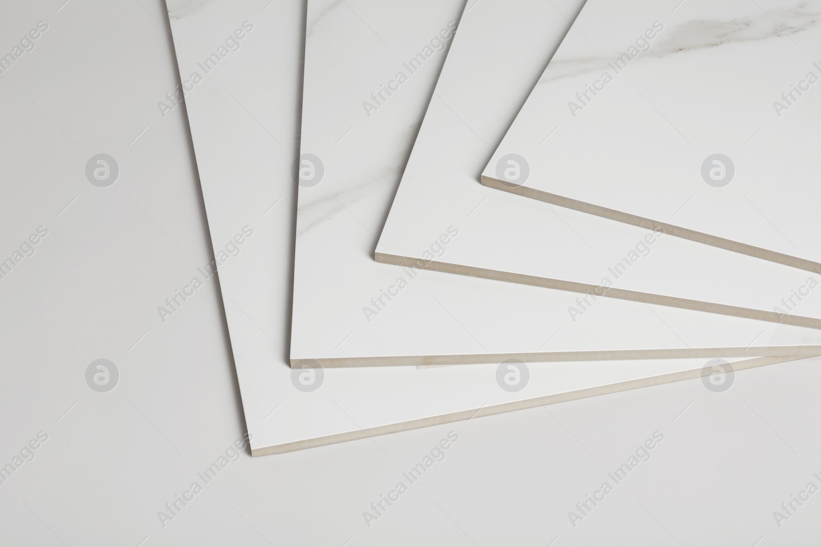 Photo of Stack of ceramic tiles on white background. Space for text