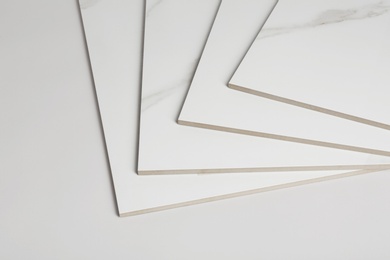 Stack of ceramic tiles on white background. Space for text