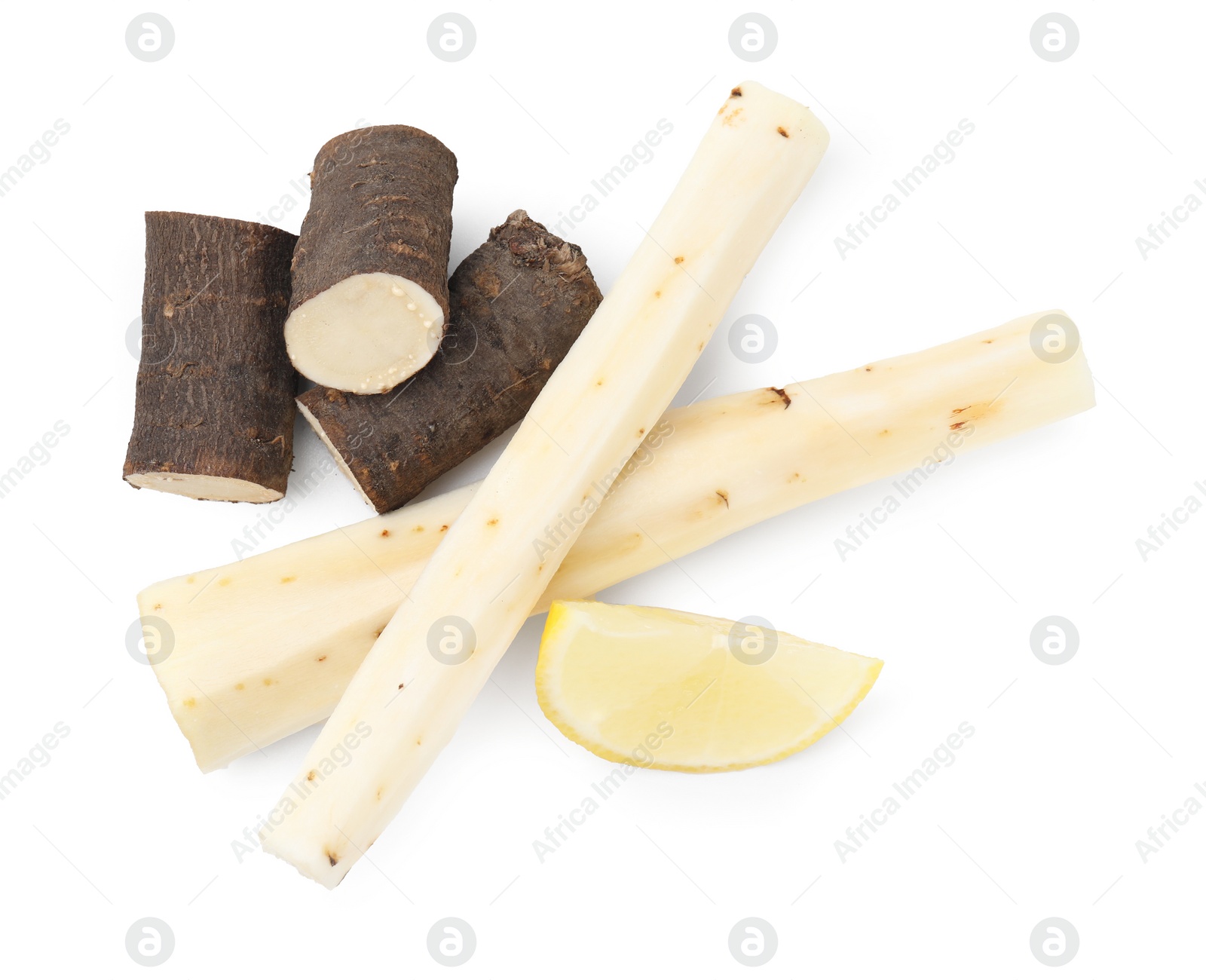 Photo of Cut raw salsify roots and lemon isolated on white, top view