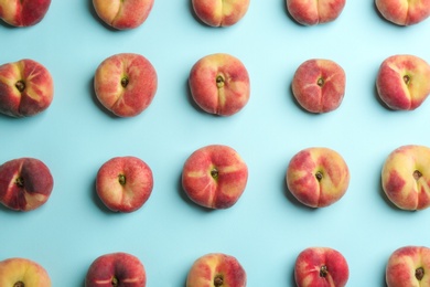 Photo of Fresh donut peaches on light blue background, flat lay