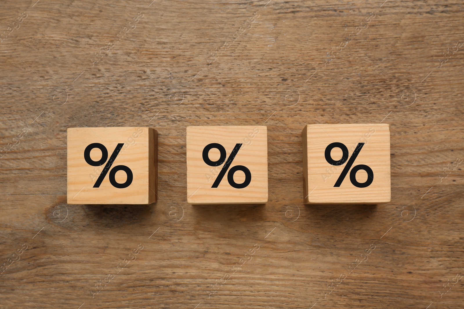 Photo of Wooden cubes with percent signs on table, flat lay