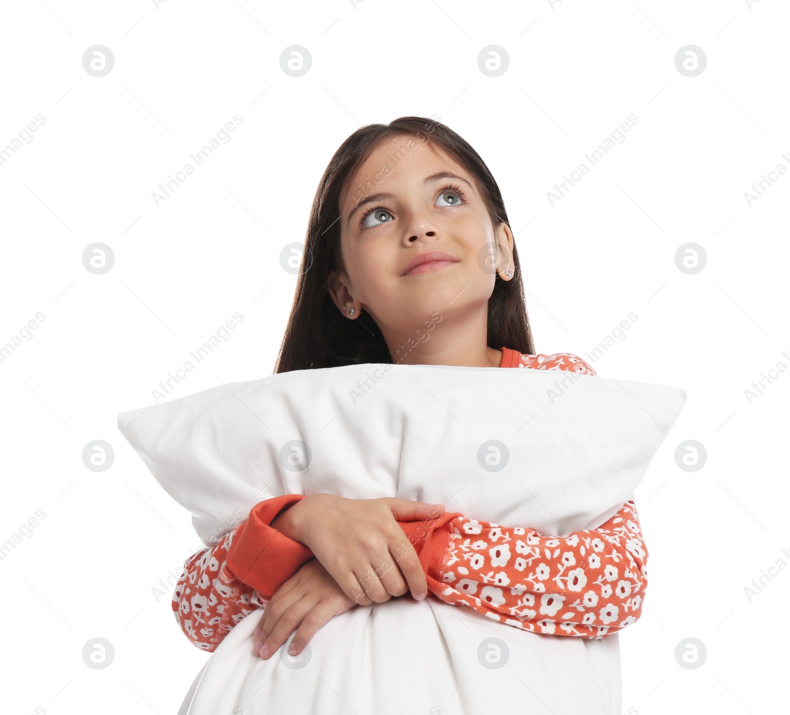 Photo of Cute girl wearing pajamas with pillow on white background
