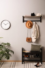 Hallway interior with stylish furniture, clothes and accessories