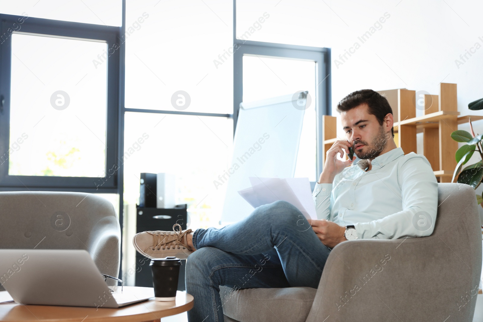 Photo of Male business trainer working with documents in office