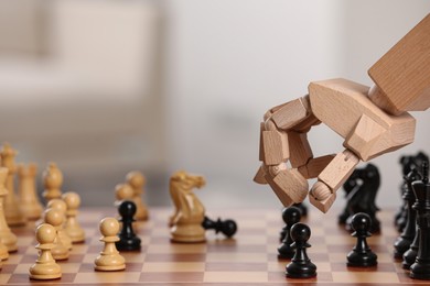 Photo of Wooden hand representing artificial intelligence. Robot moving chess piece on board against light background, closeup. Space for text