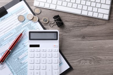 Photo of Tax accounting. Flat lay composition with calculator and document on wooden table, space for text