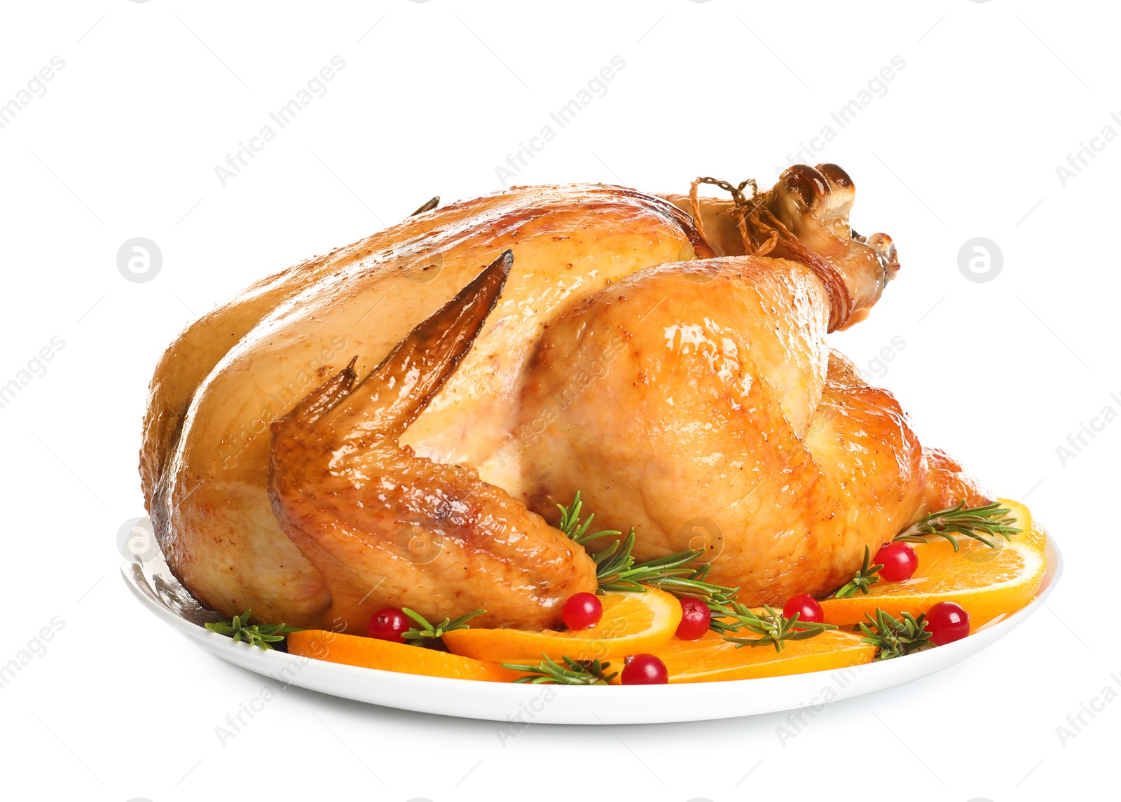 Photo of Platter of cooked turkey with garnish on white background