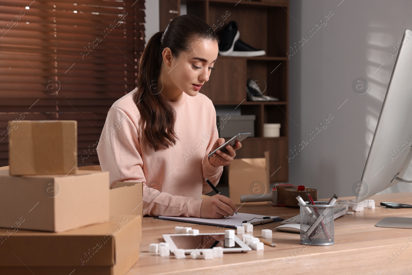 Photo of Seller working at table in office. Online store