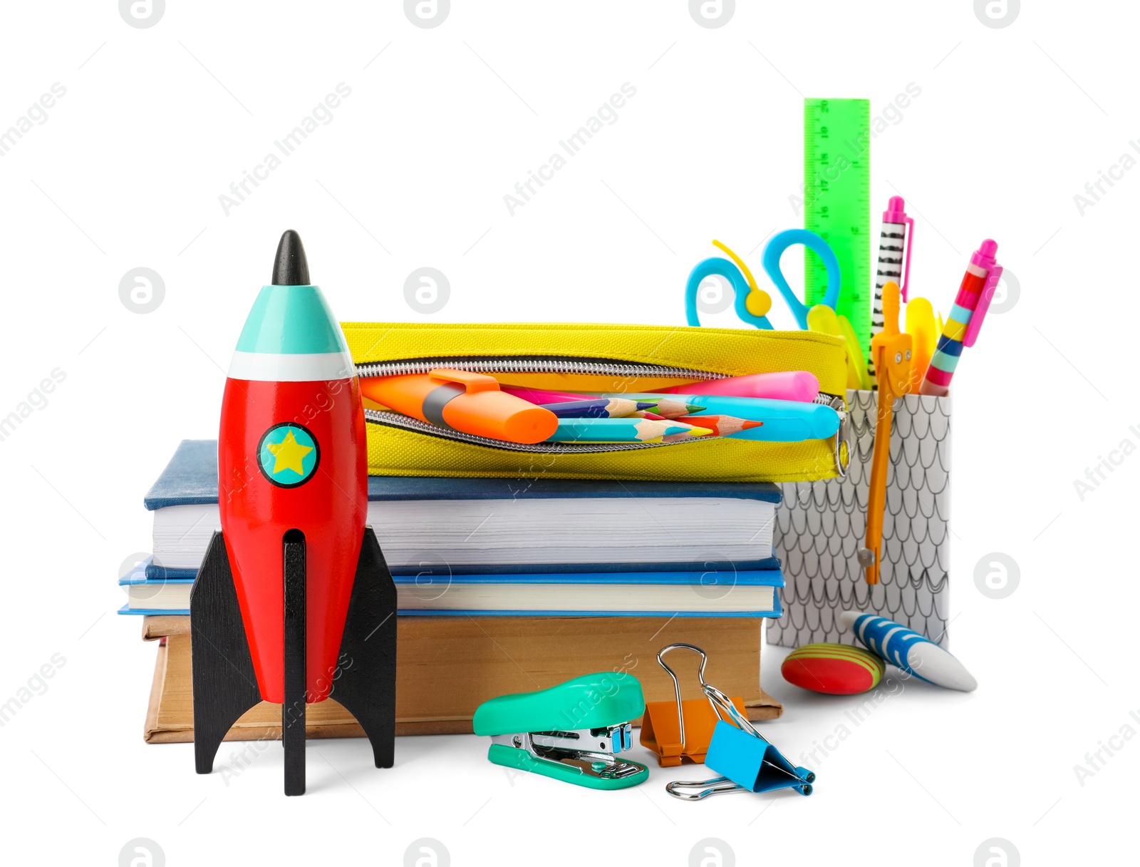 Photo of Bright toy rocket and school supplies on white background