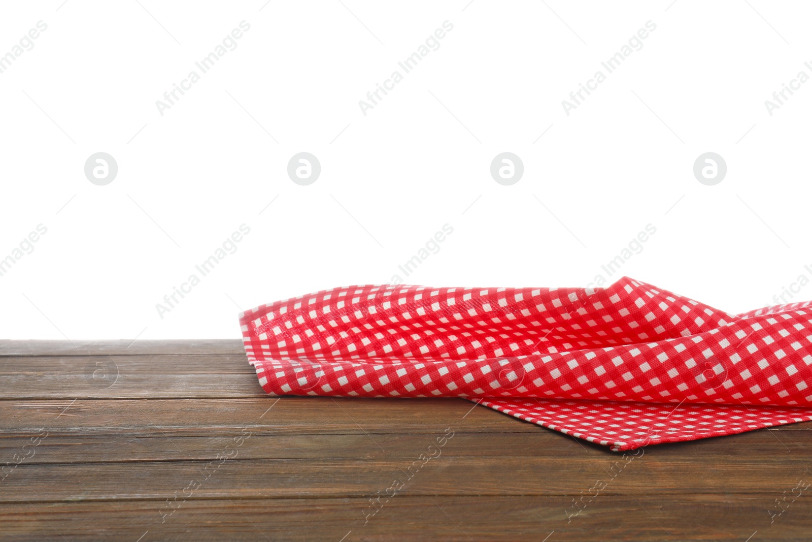 Photo of Red checkered cloth on wooden table against white background. Mockup for design