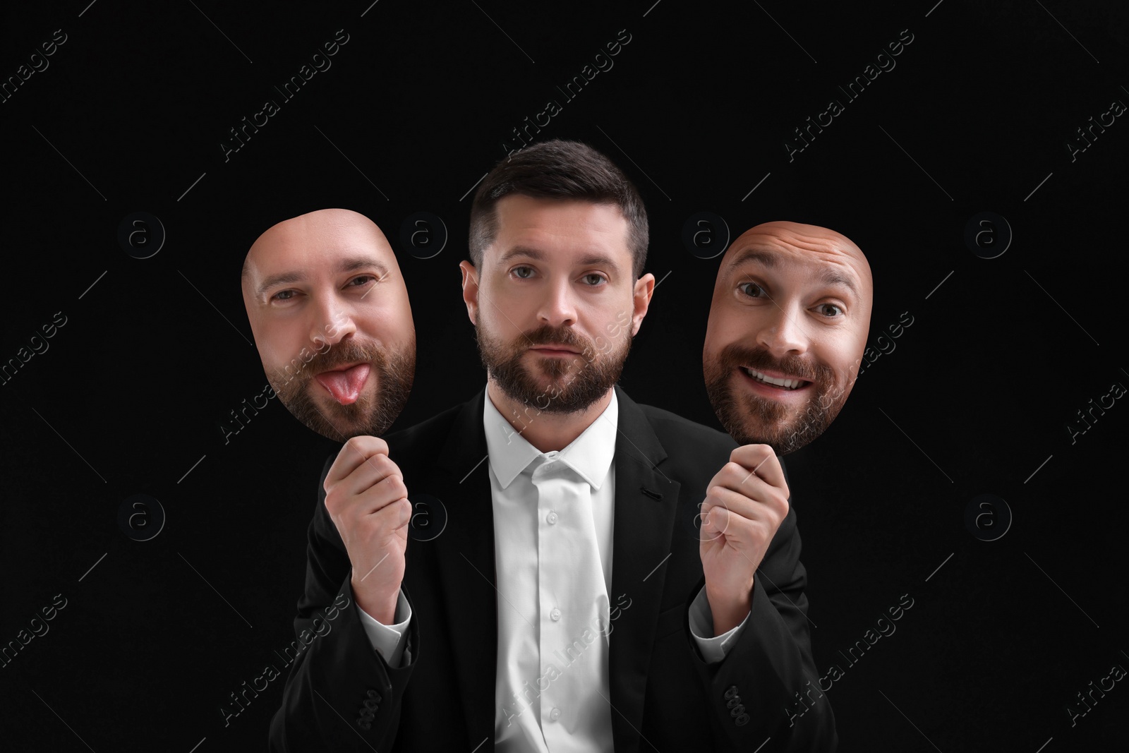 Image of Man holding masks with his face showing different emotions on black background. Balanced personality