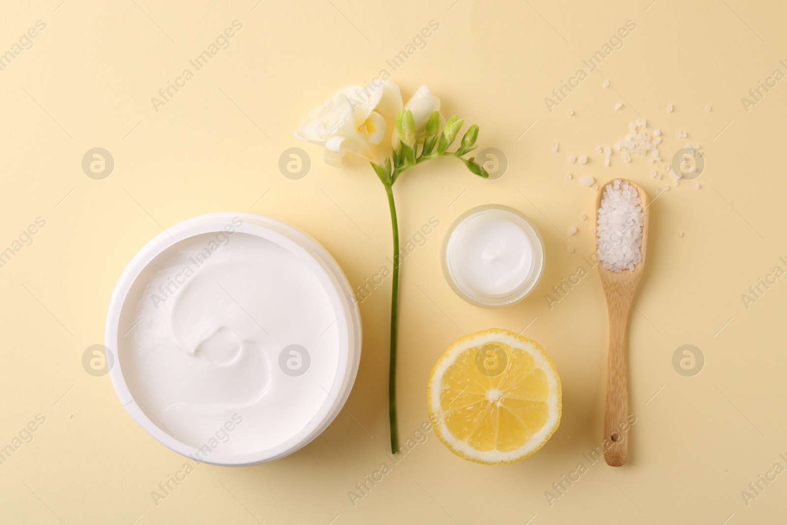 Photo of Flat lay composition with jars of cream on beige background. Body care product