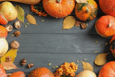 Orange pumpkins on wooden background, flat lay composition with space for text. Autumn holidays