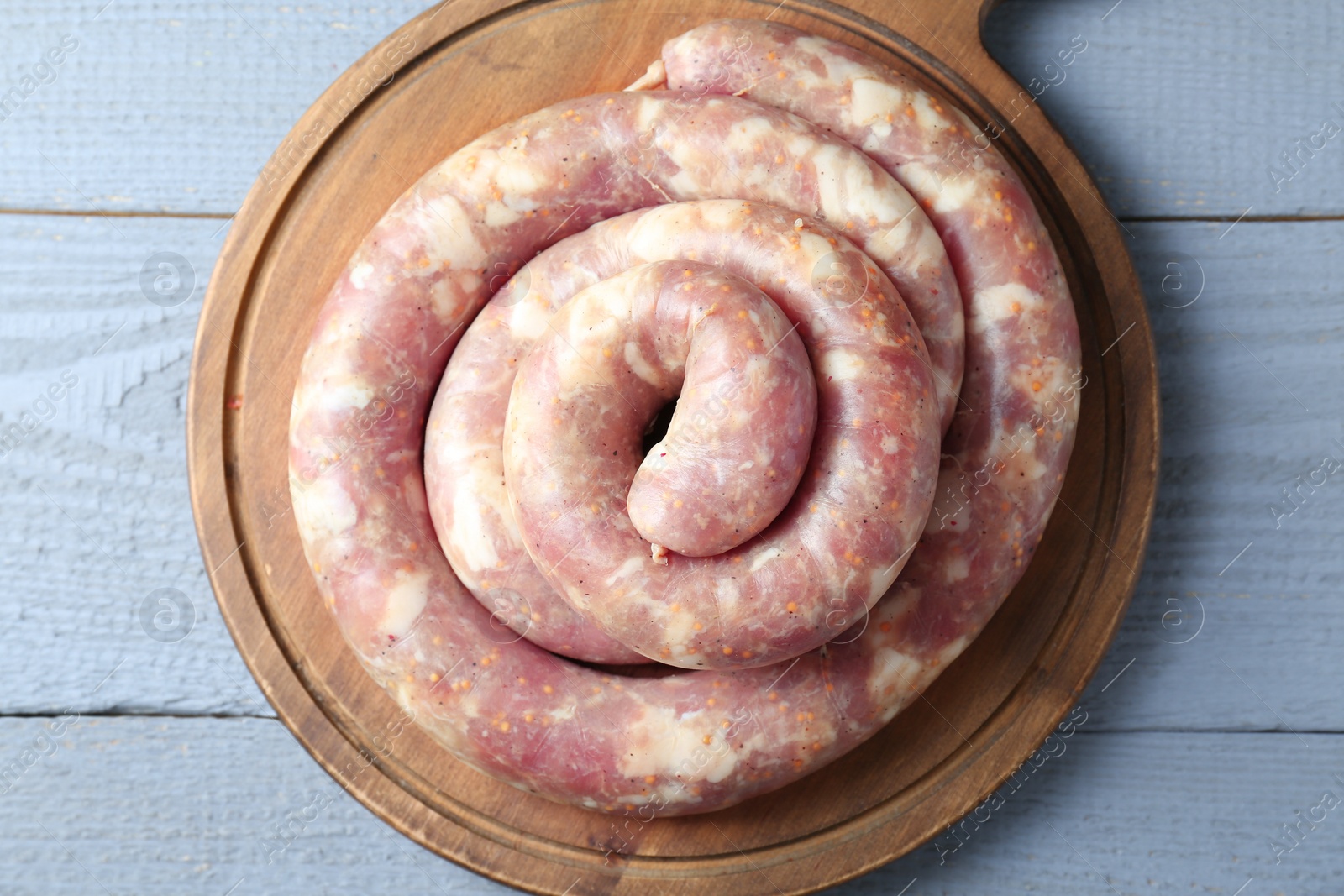 Photo of Homemade sausages on light grey wooden table, top view