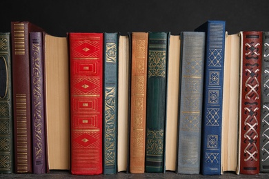 Stack of hardcover books on grey stone table