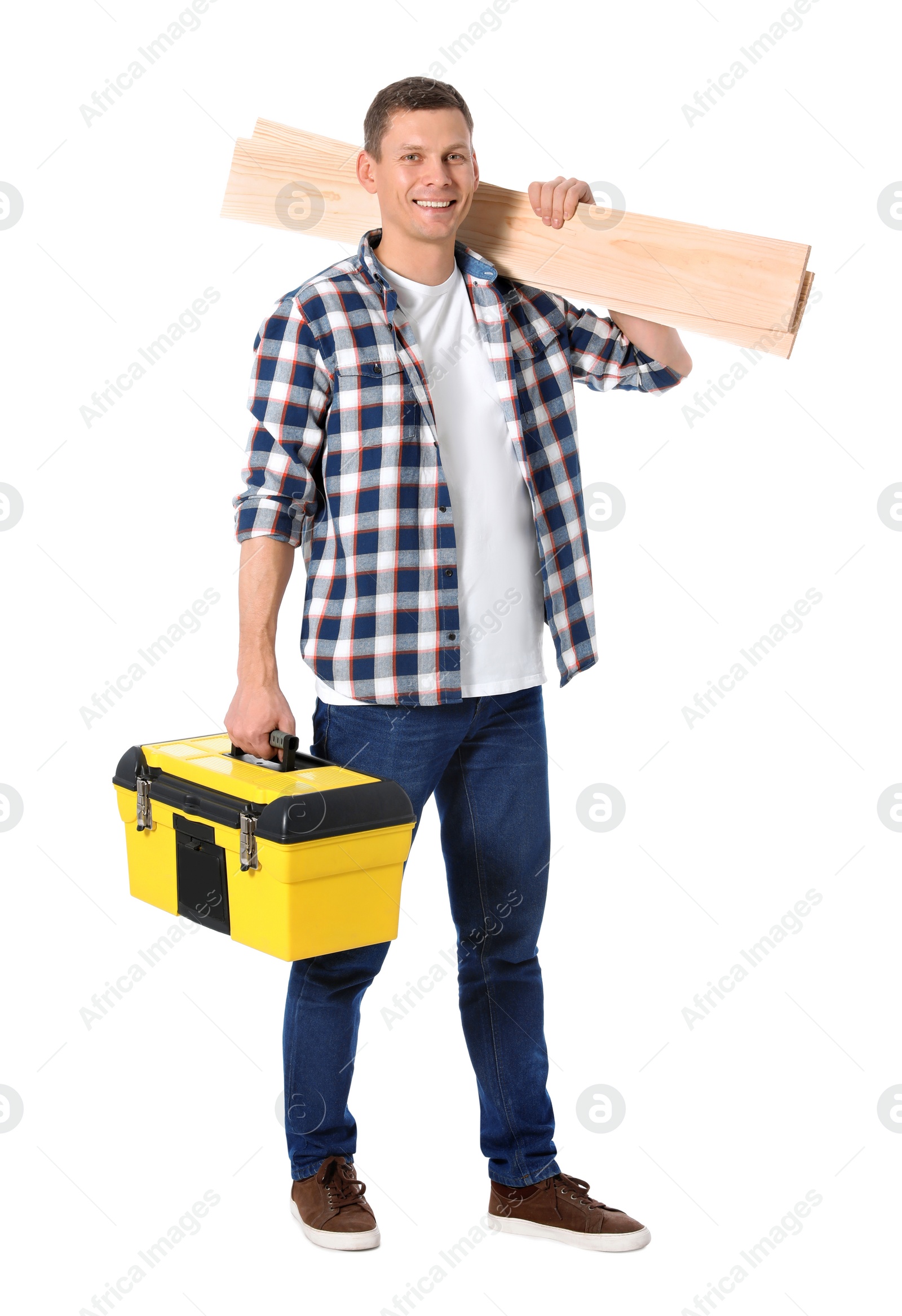 Photo of Handsome carpenter with wooden planks and tool box isolated on white