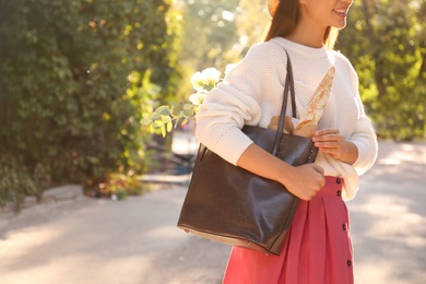 Woman with leather shopper bag outdoors, closeup