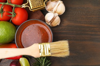 Tasty marinade and products on wooden table, flat lay. Space for text