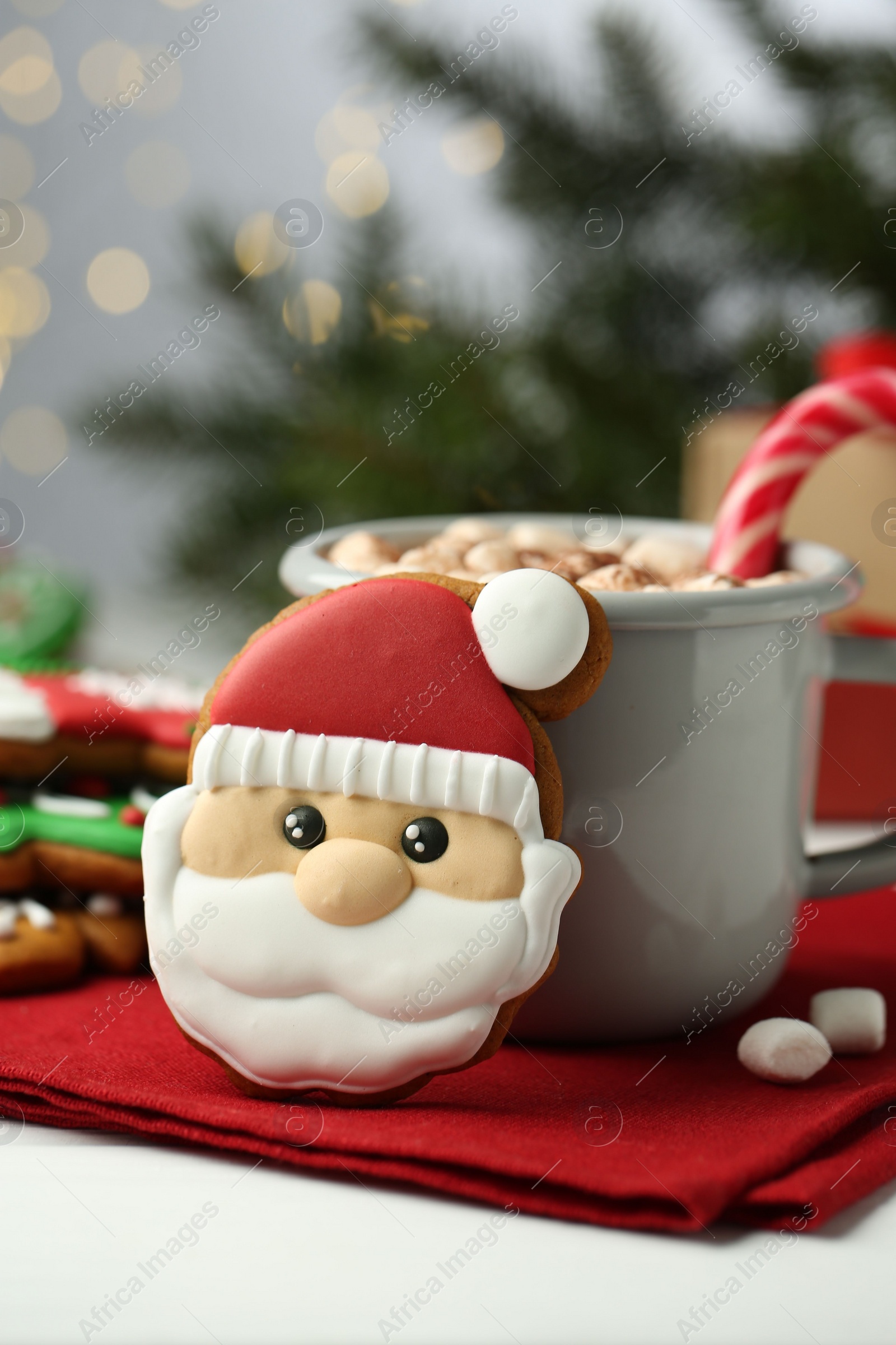 Photo of Tasty homemade Christmas cookie and hot chocolate with marshmallows on white table