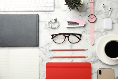 Photo of Flat lay composition with office stationery and glasses on white marble desk