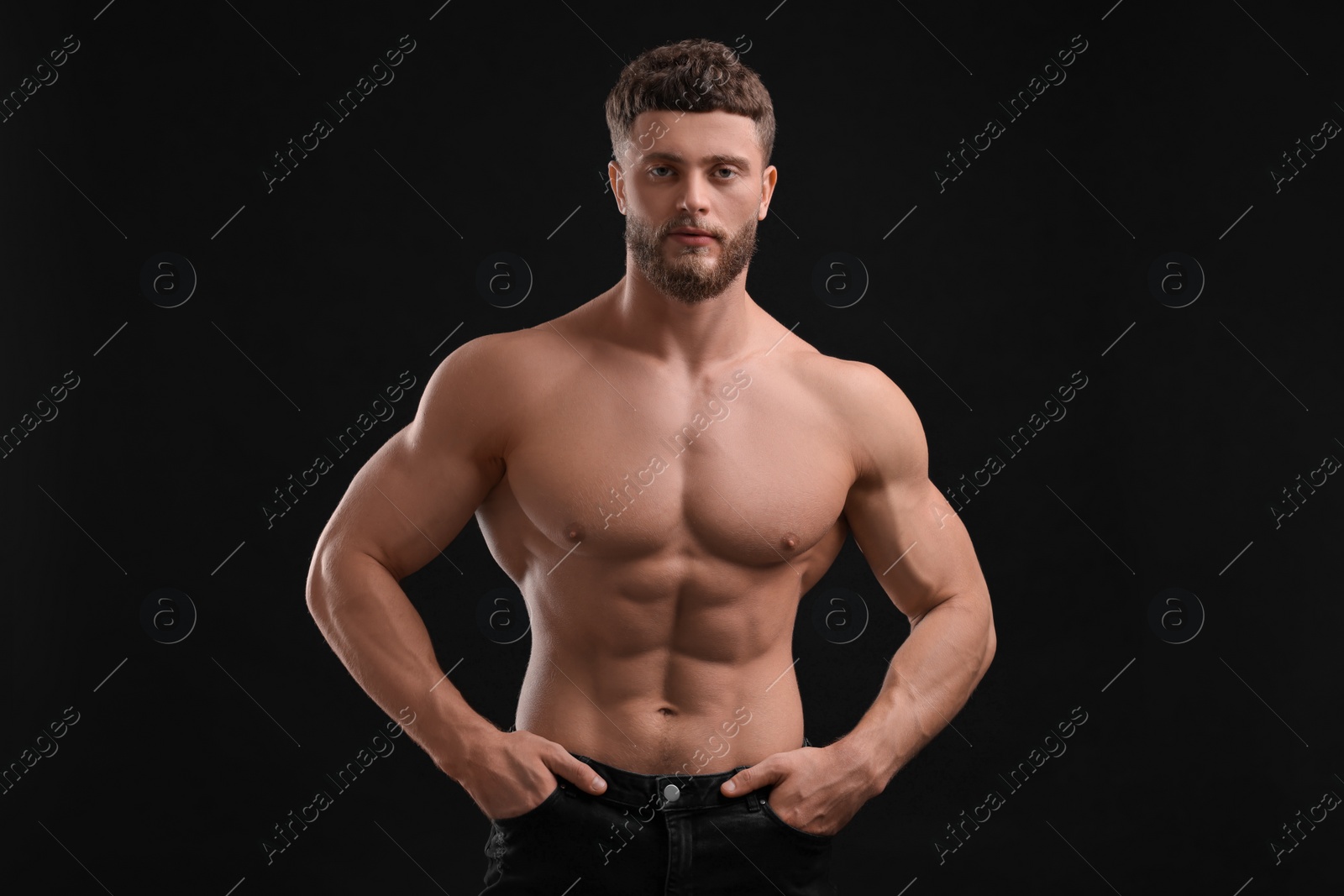 Photo of Handsome muscular man on black background. Sexy body