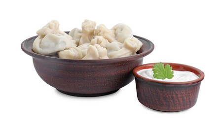 Photo of Tasty khinkali (dumplings) with sauce and parsley isolated on white. Georgian cuisine