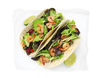 Photo of Delicious tacos with shrimps and lime on white background, top view