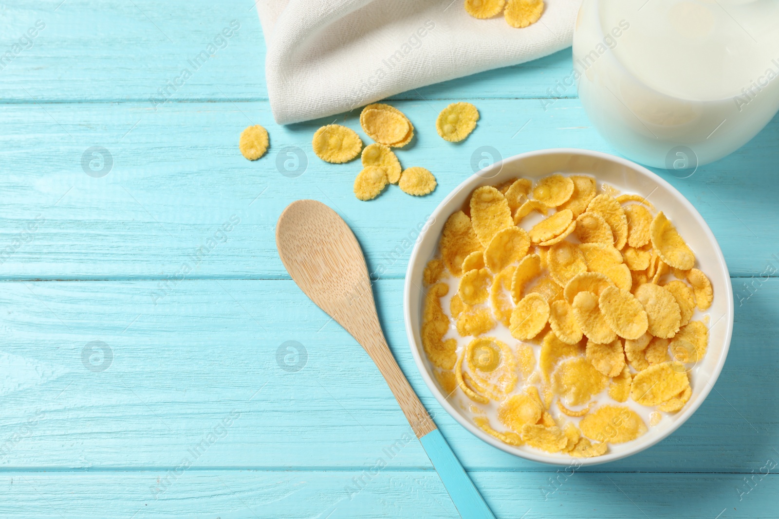 Photo of Flat lay composition with tasty corn flakes on light blue wooden table