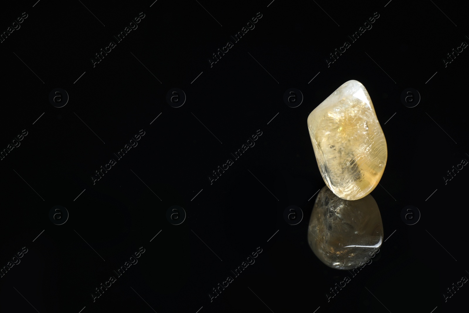 Photo of Beautiful citrine quartz gemstone on black background. Space for text