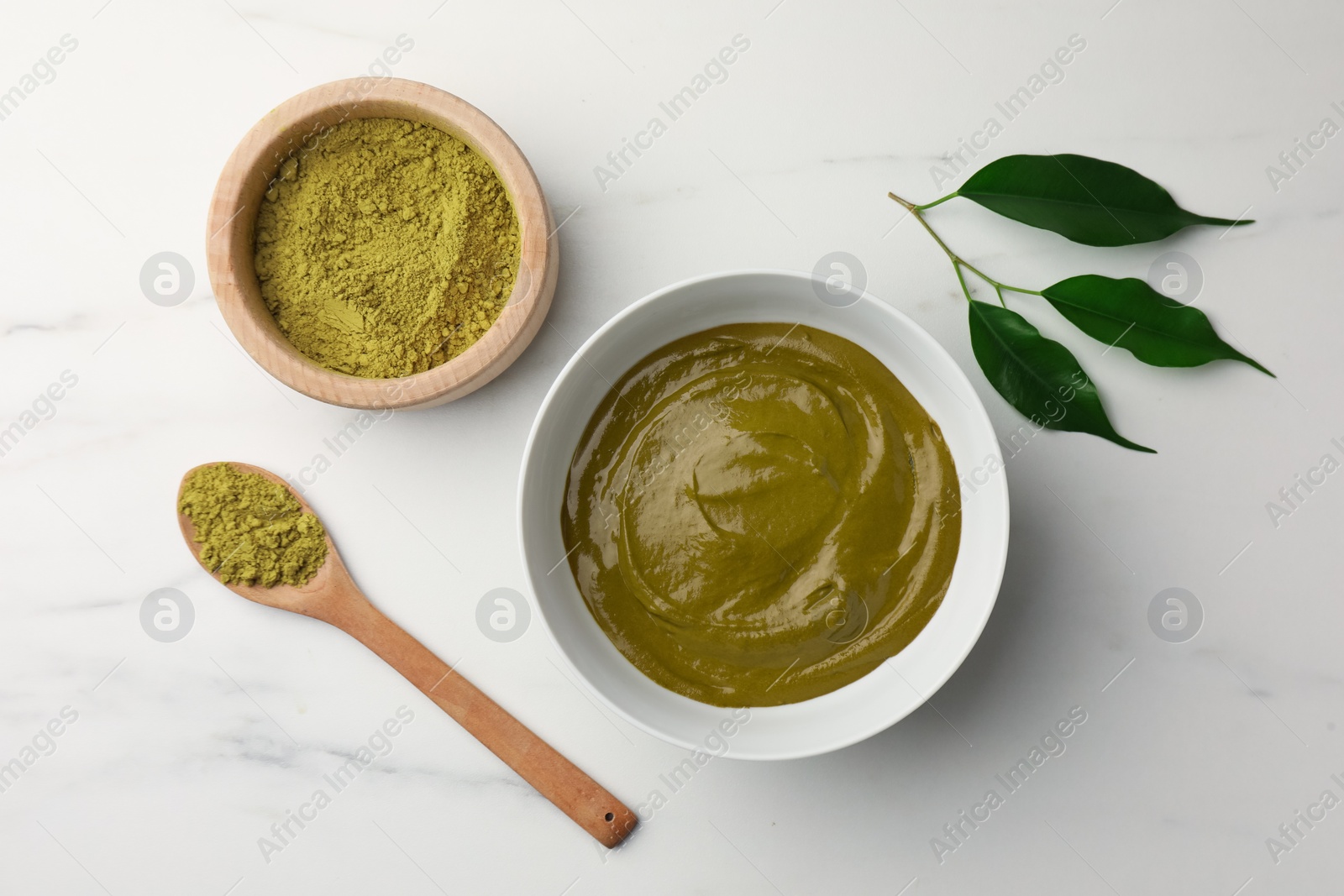 Photo of Flat lay composition with henna powder and cream on white marble table. Natural hair coloring