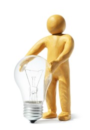 Photo of Human figure made of plasticine holding light bulb isolated on white