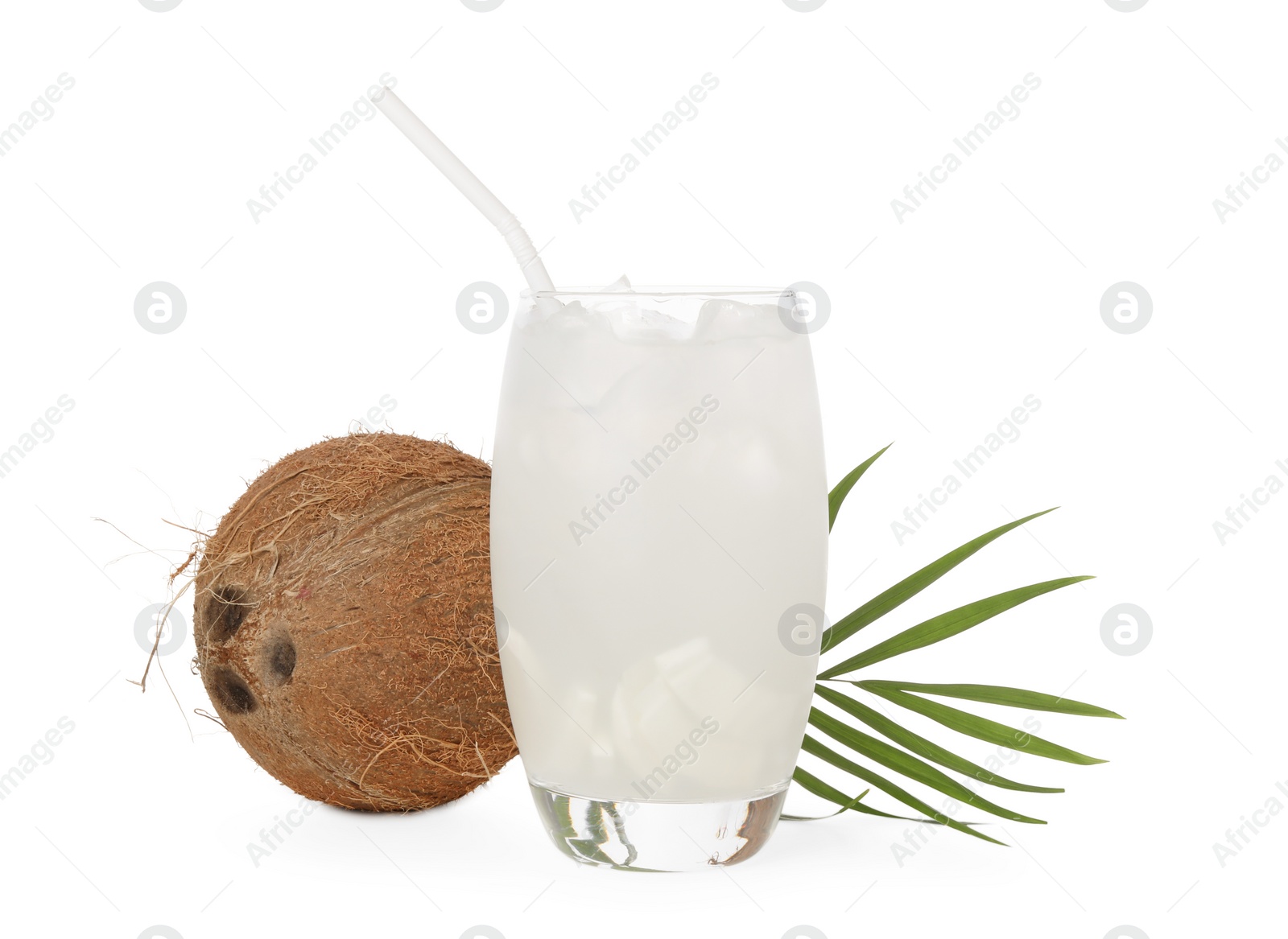 Photo of Glass of coconut water, ice cubes, leaf and nut isolated on white