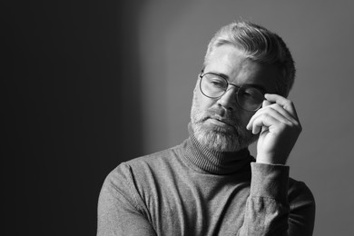 Photo of Portrait of handsome man on dark background, space for text. Black and white effect